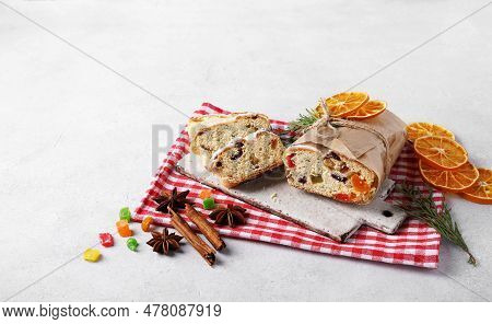 Christmas Stollen, Sliced On Red Napkin With And Decor. Homemade Traditional Cake.