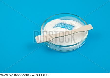 Succinic Acid Or Dicarboxylic Acid In Petri Dish On Blue, Selective Focus. Spirit Of Amber, White Po