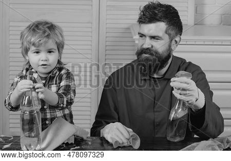 Dad And Kid Having Fun During Cleaning. Man With Child Plays With Soapsuds. Father Is Teaching A Son