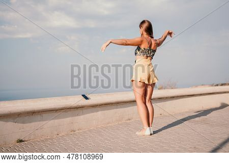 Woman Summer Dance. Silhouette Of A Happy Woman Who Dances, Spins And Raises Her Hands To The Sky. A