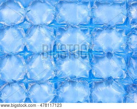 Plastic Bag With Water For Ice Close-up. Blue Plastic Packaging Ice Bags For Home Water Freezing. Ic