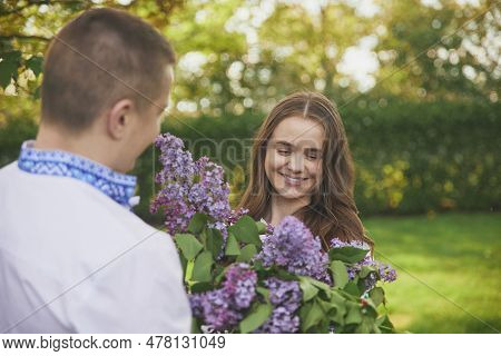 Skjern, Denmark, May 21, 2023: Couple In Love. Man Gives Flowers