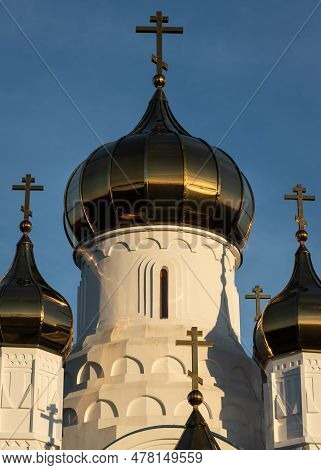 Cupola Of Russian Monastery With Russian Crosses Against Blue Sky