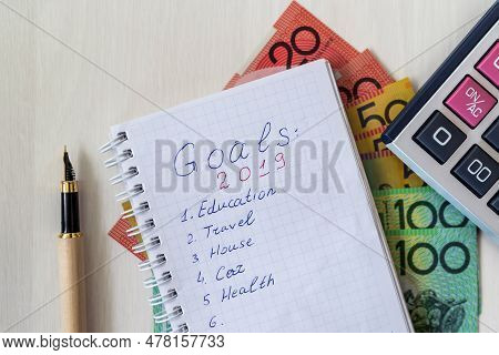 Notepad With Calculator And Austalian Dollars On Desk