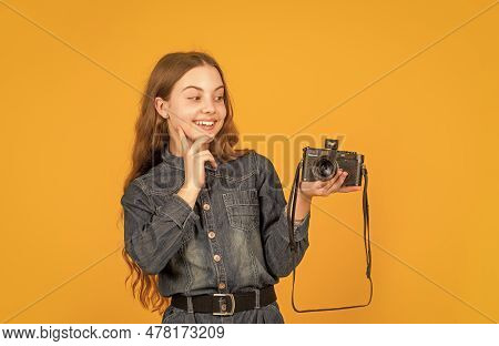 Interested In Photography. Happy Child Looking At Photo Camera. Girl Photographer With Camera