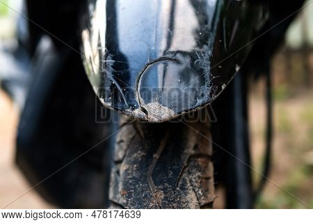 The Front Fender Of The Motorbike Is Black, The Black Body Fender Is Broken Due To Being Hit By An A
