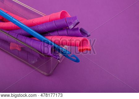Soft Curler Spiral Or Long Hair Rollers Ahd Hook In Plastic Box On Purple Background. Fashion Access