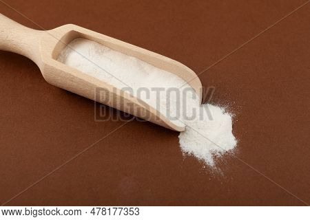 Salep Flour In Wooden Scoop, Close-up. Salep Flour Is Consumed In Beverages And Desserts.
