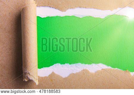 Grey Package Paper Torn To Reveal Green Panel Ideal For Copy Space.