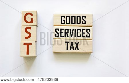 Gst Alphabet Letters On Wooden Blocks, Gst Goods And Services Tax Message On Wooden Blocks And White