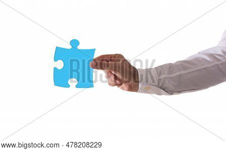 Isolated Businessman Holds A Piace Of Puzzle. Concept Teamwork, Partnership, Integration