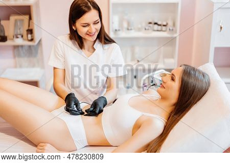 Doctor Is Doing Electroepilation To The Client, Using Electro Needle And Tweezers. Hair Removal Proc