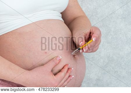 Blood Thinners Concept. Pregnant Woman Making Injection In Stomach