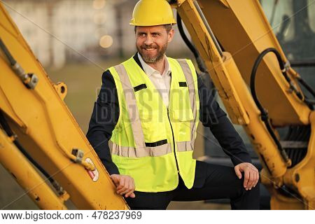 Buider Man In Suit And Hardhat. Construction Investor. Business Man Investor In Front Of Constructio