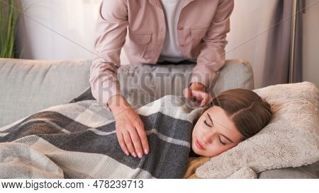 Home Nap. Parent Care. Unrecognizable Woman Covering Plaid Teenager Girl Sleeping On Sofa Weekend Dr
