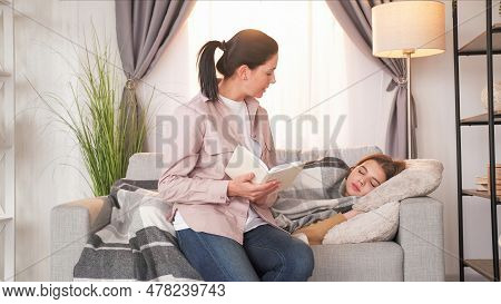 Family Reading. Parent Leisure. Loving Mother Declaiming Interesting Story From Book To Napping Teen