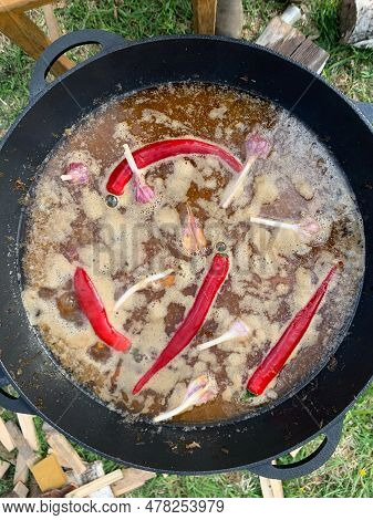 Cauldron With Pilaf, Top View. Picnic, Barbecue. Process Of Cooking An Oriental Dish In The Open Air