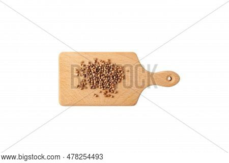Dried Coriander Seeds On Wooden Cutting Board. Design Element.  White Background, Copy Space.