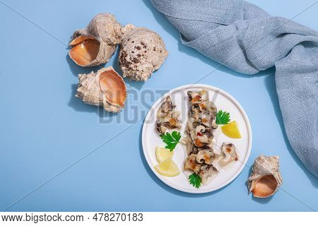 Pickled Rapan Meat With Oil, Spices And Greens. Healthy Seafood Rich Of Omega