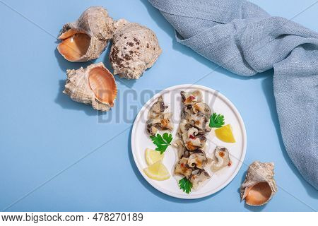 Pickled Rapan Meat With Oil, Spices And Greens. Healthy Seafood Rich Of Omega