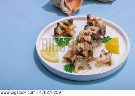 Pickled Rapan Meat With Oil, Spices And Greens. Healthy Seafood Rich Of Omega