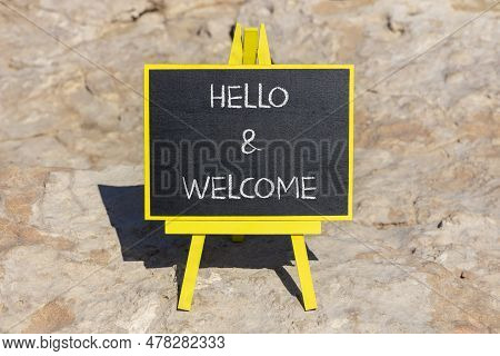 Hello And Welcome Symbol. Concept Words Hello And Welcome On Black Chalk Blackboard On A Beautiful S
