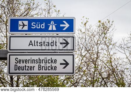 Selective Blur On German Roadsign In Cologne, Germany, Directing To Autobahn Motorway Heading South 