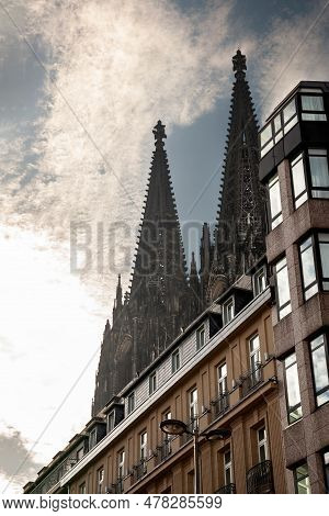 Cologne Cathedral With A Residential Apartment Building In Front With A Sunset Sky. Cologne Cathedra