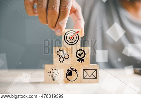 Businessmans Hand Strategically Arranging Wood Blocks, Symbolizing Business Strategy, Action Plan, A
