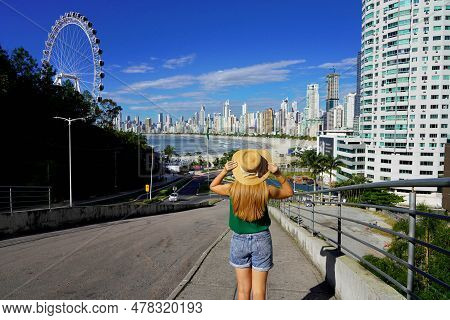 Holidays In Brazil. Back View Of Young Woman Enjoying Balneario Camboriu City Skyline With Ferris Wh
