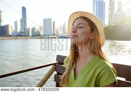 Close-up Of Beautiful Young Stylish Woman Enjoying Balneario Camboriu City Feelings. Travel In Brazi