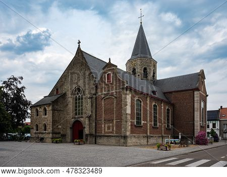 Kalken, Laarne, Belgium, June 16, 2023 - The Brick Stone Saint Denis Church In The Village Center