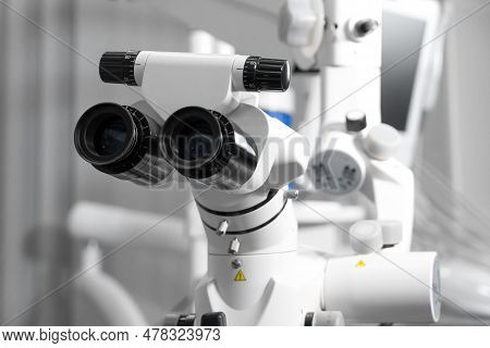 Surgical Microscope In Dental Clinic. Microsurgical With Doctors. Modern Dental Equipment And Instru