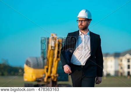 Construction Manager In Suit And Helmet At A Construction Site. Construction Manager Worker Or Super