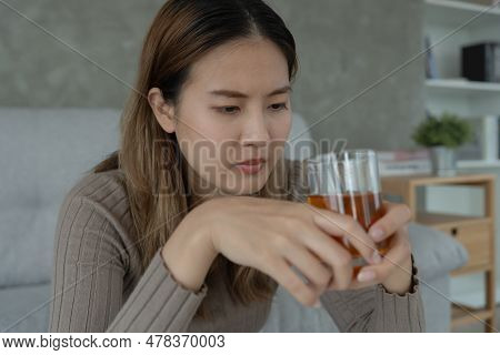 Depressed Young Asian Woman Addicted Feeling Bad Drinking Whiskey Alone At Home, Stressed Frustrated