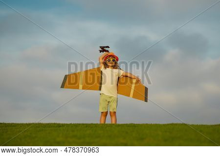 Little Child Boy Is Playing And Dreaming Of Flying Over The Clouds. Child Boy Toddler Playing With T