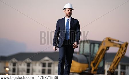 Construction Manager In Suit And Helmet At A Construction Site. Construction Manager Worker Or Super