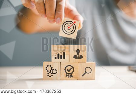 Hand Skillfully Arranging Wood Blocks, Symbolizing A Business Strategy And Action Plan. Targeting Th
