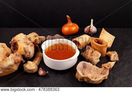 Homemade Beef Bone Broth On Dark Background. Bones Contain Collagen, Which Provides The Body With Am