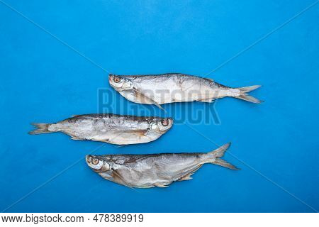Salty Dried Fish On Blue Background. Sabrefish (pelecus Cultratus) - Popular Beer Appetizer.