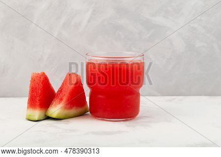 Watermelon Smoothie Or Watermelon Juice In Clear Glass On Grey Background. Near Lie Juicy Slices Wit