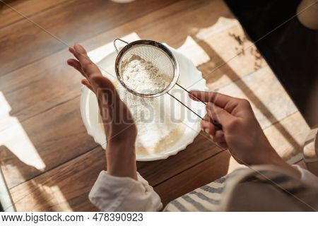 Sieving Flour For Cooking Tasty And Airy Bread. Girl Using Sieve For Flour To Make It Airy For Bakin