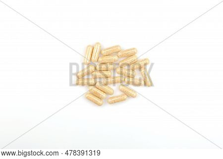 Heap Hulbah Pills On White Background. Herbal Nutritional Supplements. Hulbah Pills Help Reduce Disc