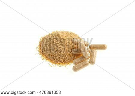 Hulbah Pills And Pile Fenugreek Powder On White Background, Selective Focus. Hulbah Pills Help Reduc