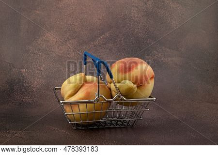 Ugly Fruits Concept. Deformed Peaches In Shopping Basket. Reduce Organic Food Waste. Last Trend - Ea