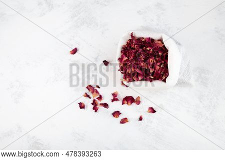 Dried Pink Rose Petals In Pouch On Light Grey Background, Top View.  Organic Red Dry Petals Used For