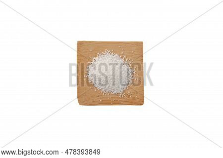 Sodium Benzoate On Wooden Square Plate, Top View. Sodium Salt Of Benzoic Acid. White Granulated Powd