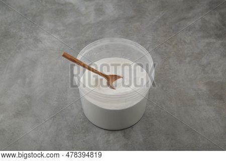 Succinic Acid Or Dicarboxylic Acid In Plastic Container On Grey Background. Food Additive E363. Spir