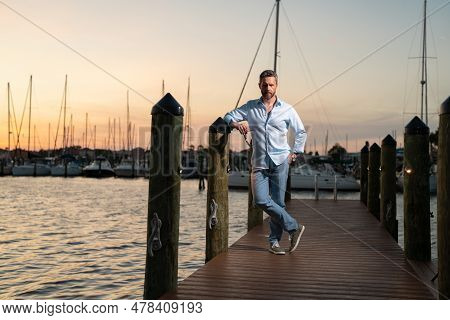 Fashion Business Man Near The Yacht. Portrait Of Fashion Model Outdoor. Fashion Male Posing Near Yac