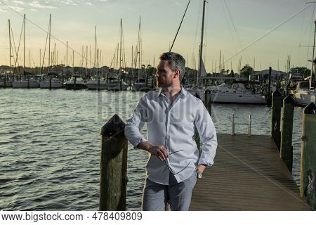 Rich Summer Business Man Near The Yacht. Portrait Of Fashion Male Model Outdoor. Rich Male Posing Ne